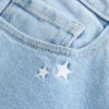 Calças de ganga bootcut com bordado de estrelas e cintura baixa