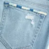Calças de ganga bootcut rasgadas, de cintura baixa, com lavagem clara e bordados
