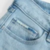 Calças de ganga bootcut rasgadas, de cintura baixa, com lavagem clara e bordados