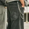 Calças de ganga largas com bordado de cobra em preto lavado