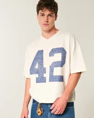 Camiseta de futebol americano com estampa gráfica, estilo universitário, folgada e pesada