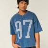 Camiseta de futebol americano com estampa gráfica, estilo universitário, folgada e pesada