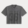 Camiseta de futebol americano com estampa gráfica, estilo universitário, folgada e pesada