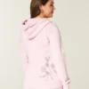 Casaco com capuz e fecho com estampado de rosas