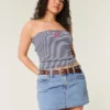 Mini-saia-calça de ganga curvilínea de cintura baixa e lavagem média Mini-saia-calça de ganga curvilínea de cintura baixa e lavagem média
