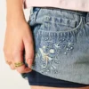 Mini-saia-calça em ganga de cintura ultra baixa