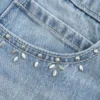 Mini-saia-calça jeans clara com tachas Mini-saia-calça jeans clara com tachas