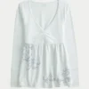 Top babydoll com mangas compridas e estampado