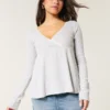Top babydoll de manga comprida com ponto aberto Top babydoll de manga comprida com ponto aberto