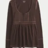 Top babydoll Henley de manga comprida